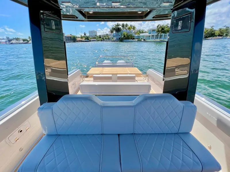 Slide: The Image of Interior view of 2025 Schaefer V33 yacht with blue seating and waterfront backdrop. - 13