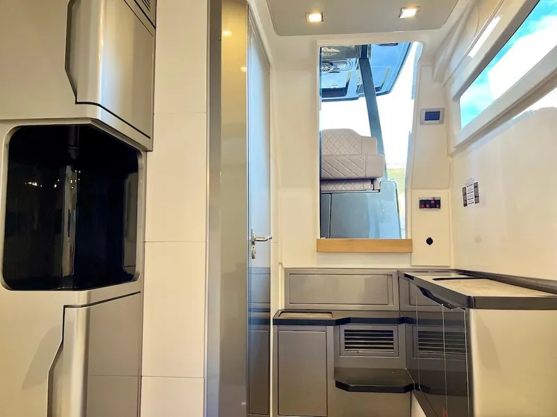 Slide: The Image of Modern interior of Schaefer V33 yacht, 2025 model, featuring sleek cabinetry and seating. - 27