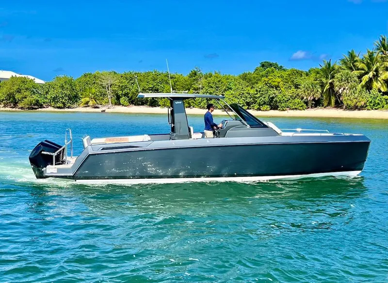 Slide: The Image of 2025 Schaefer V33 boat cruising near a tropical island. - 4