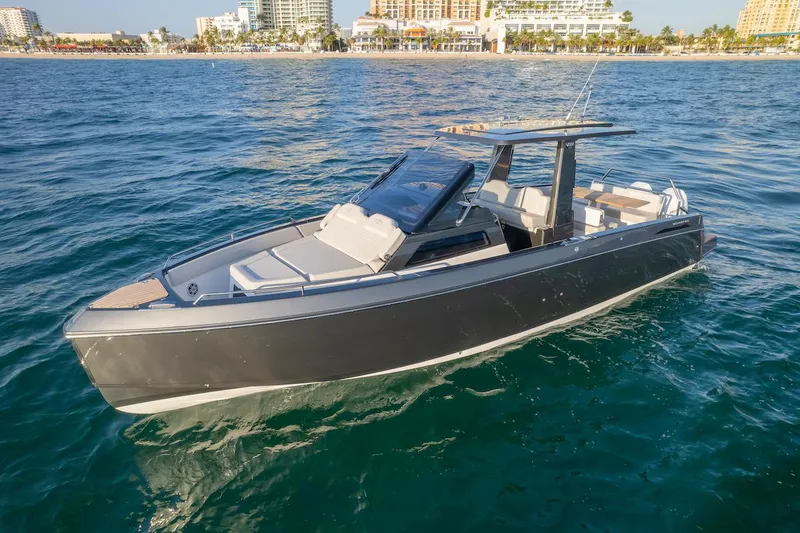 Slide: The Image of 2025 Schaefer V33 boat cruising near a coastal city. - 8