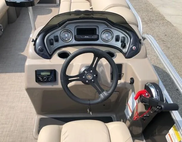 Slide: The Image of 2023 Sun Tracker Party Barge 22 DLX helm with steering wheel and control panel. - 13