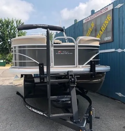 Slide: The Image of 2023 Sun Tracker Party Barge 22 DLX pontoon boat on trailer at dealership. - 2