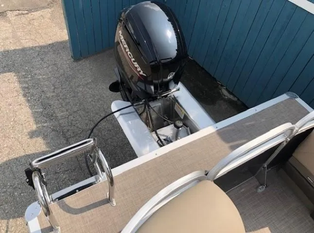 Slide: The Image of 2023 Sun Tracker Party Barge 22 DLX with Mercury outboard motor, rear view. - 22