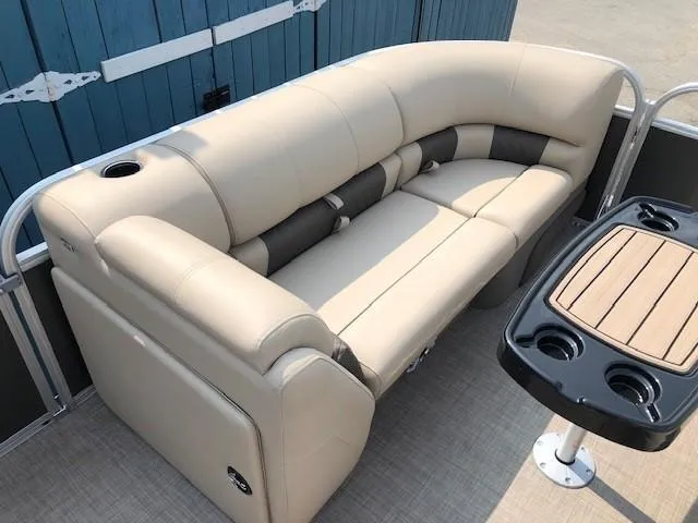 Slide: The Image of 2023 Sun Tracker Party Barge 22 DLX beige seating and table with cup holders. - 9
