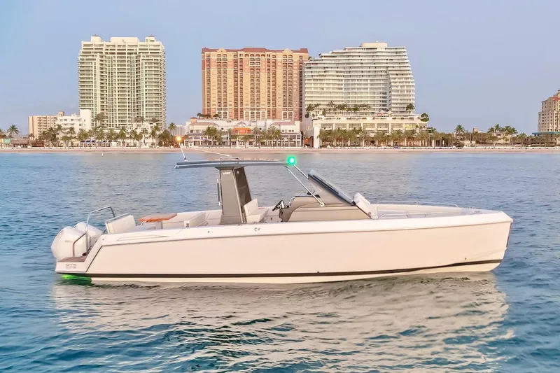 Slide: The Image of 2025 Schaefer V33 boat on calm water with city skyline in the background. - 12