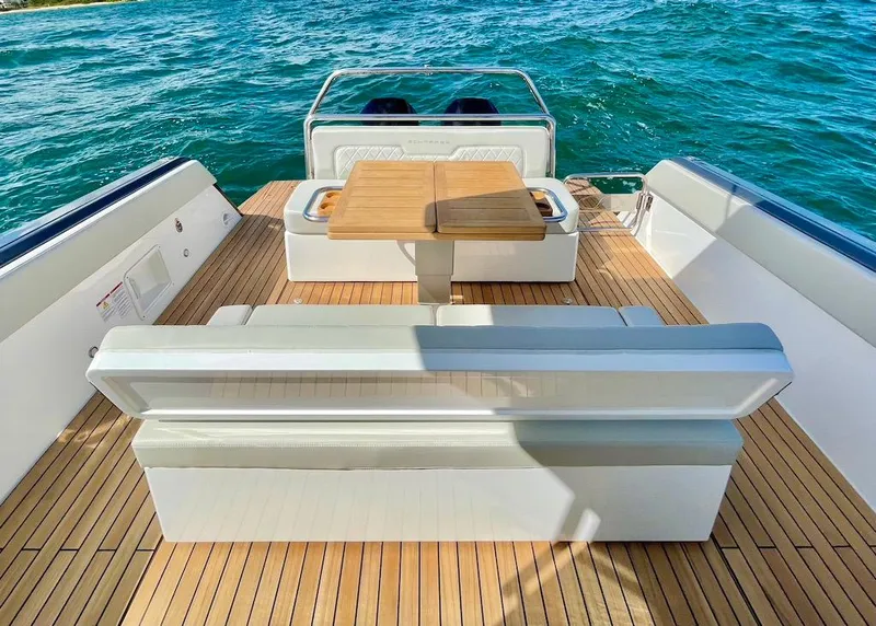 Slide: The Image of Luxury deck of 2025 Schaefer V33 boat with wooden flooring and seating area. - 18
