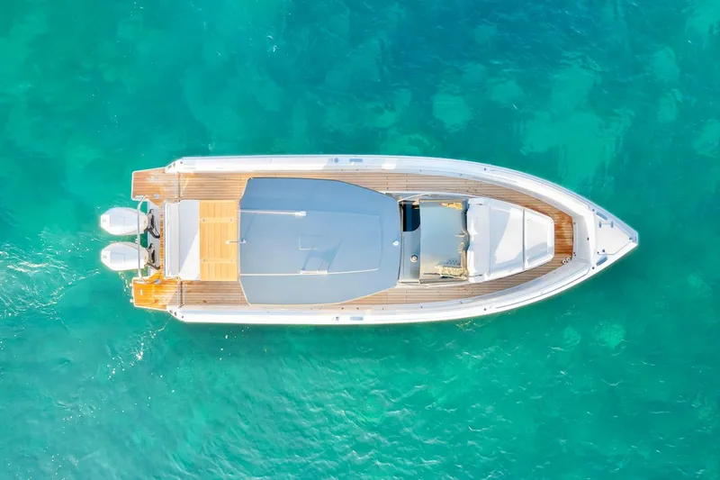 Slide: The Image of Aerial view of 2025 Schaefer V33 boat on clear turquoise water. - 2
