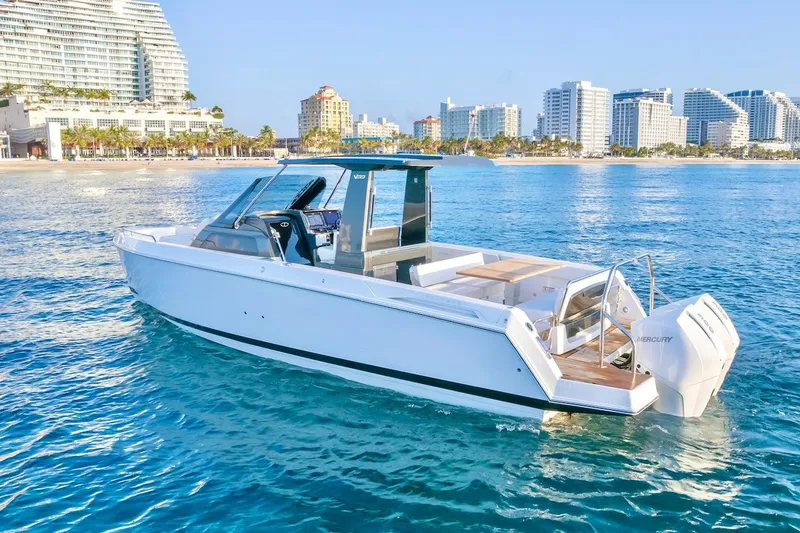 Slide: The Image of 2025 Schaefer V33 boat cruising near a coastal city skyline. - 3