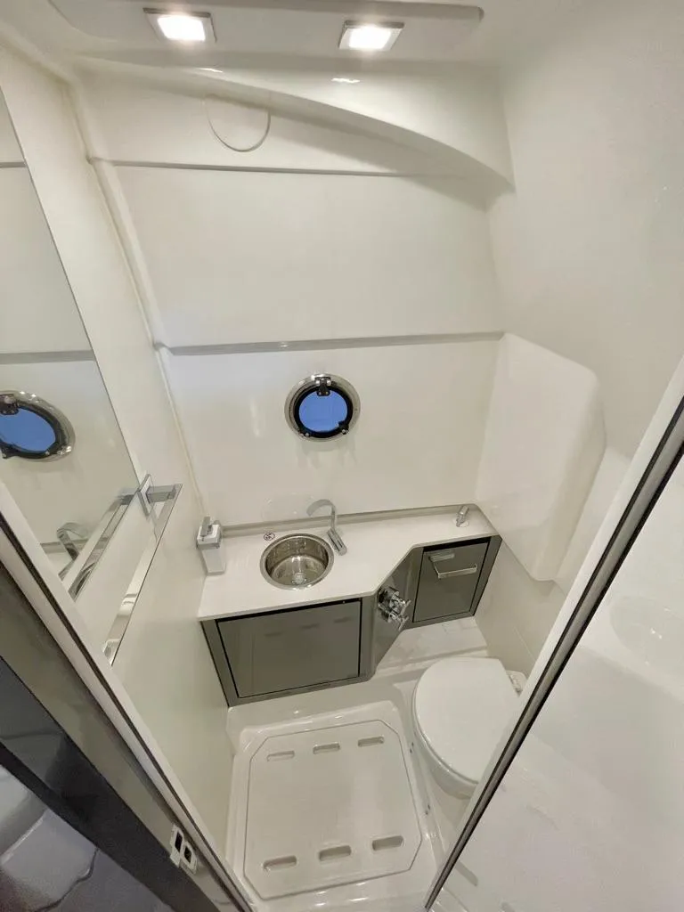 Slide: The Image of Modern bathroom in 2025 Schaefer V33 yacht with sink, toilet, and porthole window. - 30