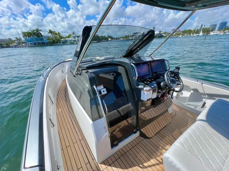 Slide: The Image of 2025 Schaefer V33 boat interior with modern dashboard and waterfront view. - 7