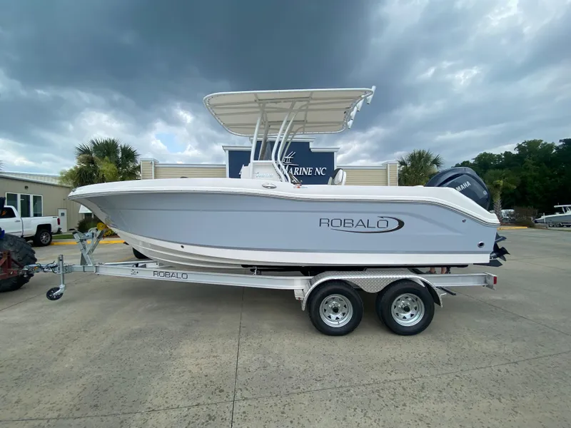 The Image of 2024 Robalo 202 EXPLORER boat on a trailer in a parking lot. - 0
