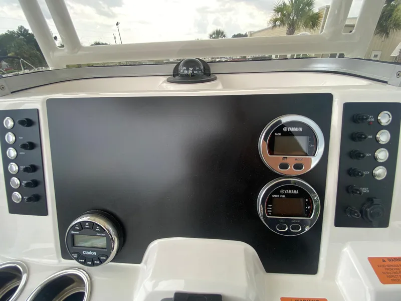 Slide: The Image of 2024 Robalo 202 EXPLORER boat dashboard with Yamaha gauges and controls. - 13