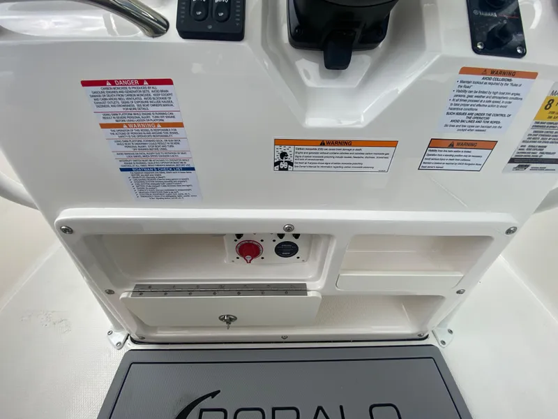 Slide: The Image of 2024 Robalo 202 EXPLORER console with safety warnings and storage compartments. - 14