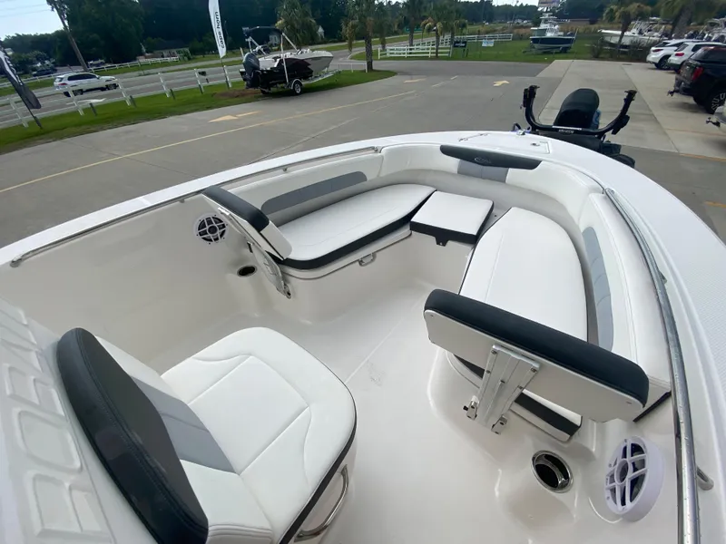 Slide: The Image of 2024 Robalo 202 EXPLORER boat interior with white and gray seating. - 17
