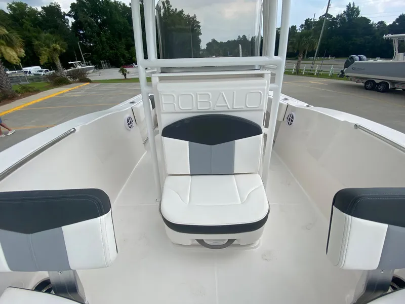Slide: The Image of 2024 Robalo 202 EXPLORER boat interior with white and gray seating. - 21