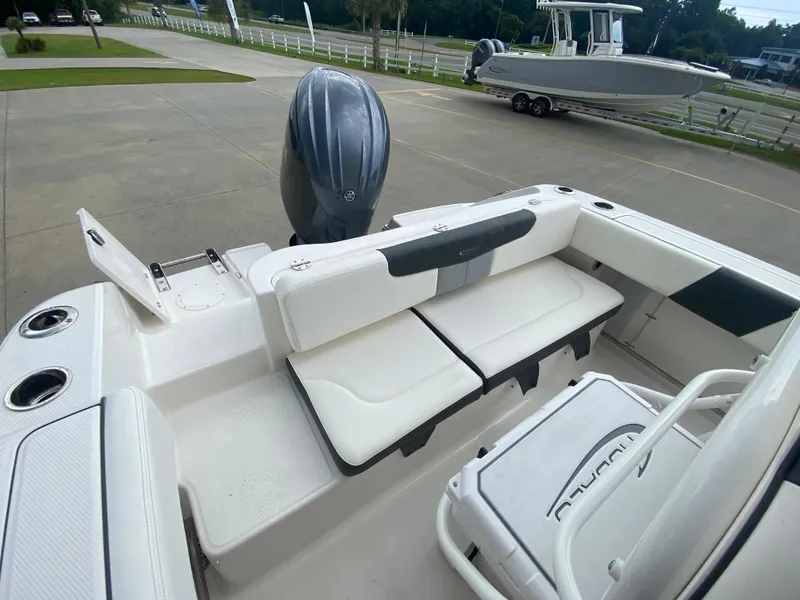 Slide: The Image of 2024 Robalo 202 EXPLORER boat with white seating and outboard motor. - 7