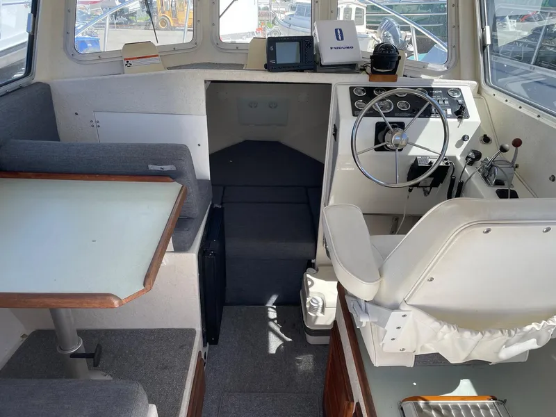 Slide: The Image of 2004 SeaSport 2400 XL boat interior with helm, seating, and navigation equipment. - 15