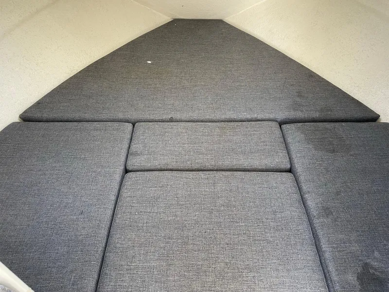 Slide: The Image of 2004 SeaSport 2400 XL boat interior with cushioned sleeping area. - 17