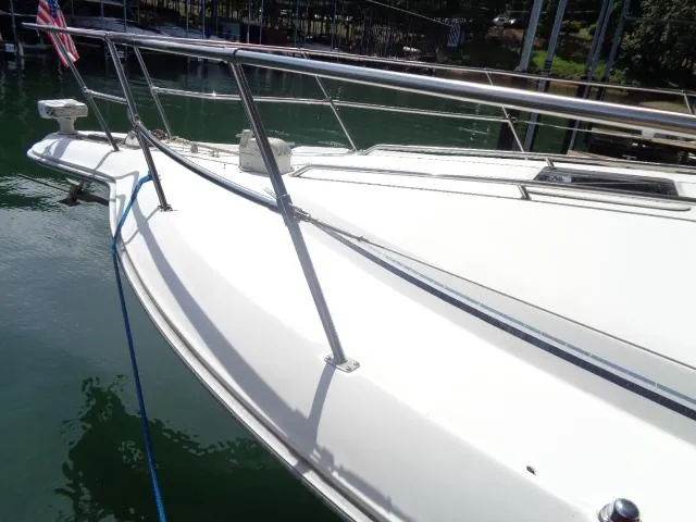 Slide: The Image of 1995 Sea Ray 400 Express Cruiser docked, showing bow and railings. - 15