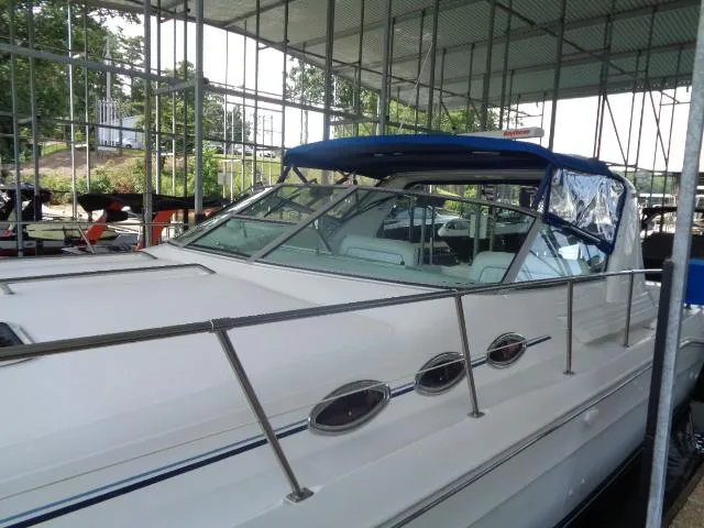 Slide: The Image of 1995 Sea Ray 400 Express Cruiser docked under a covered marina. - 17