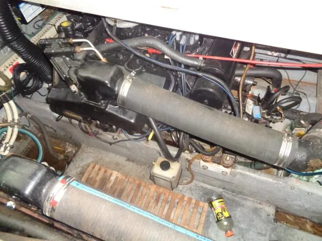 Slide: The Image of Engine compartment of a 1995 Sea Ray 400 Express Cruiser with visible hoses and components. - 20