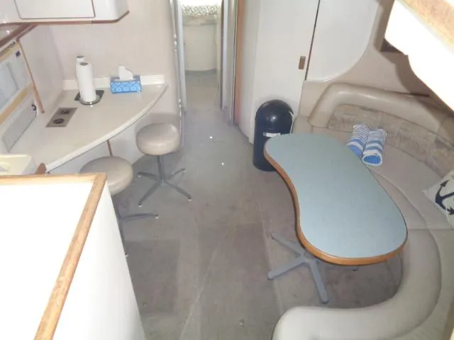 Slide: The Image of Interior of 1995 Sea Ray 400 Express Cruiser with kitchen and seating area. - 3