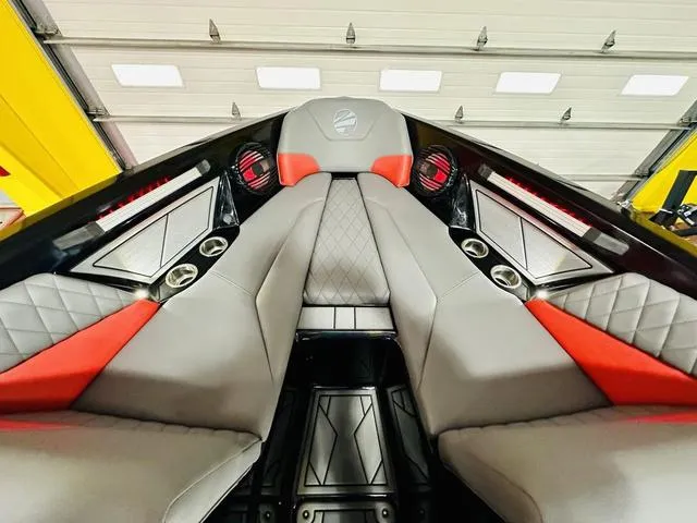 Slide: The Image of 2024 Tigé Z3 boat interior with gray and red upholstery, diamond stitching, and cup holders. - 11