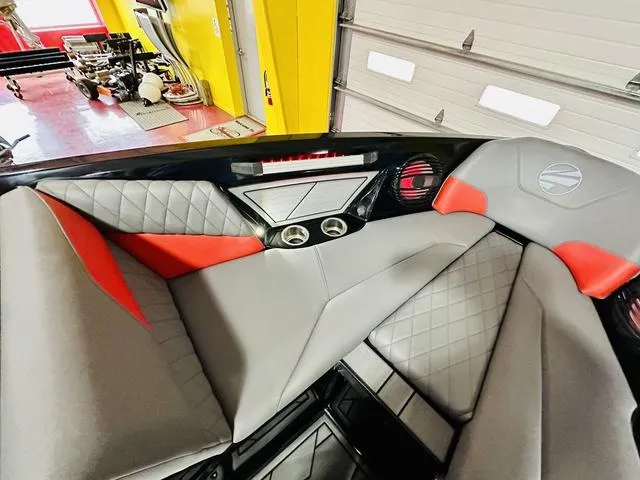 Slide: The Image of 2024 Tigé Z3 boat interior with gray and red upholstery, diamond stitching, and cup holders. - 12