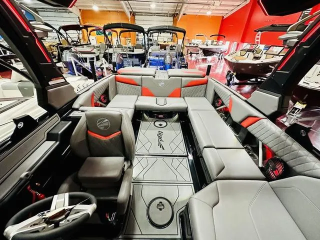 Slide: The Image of 2024 Tigé Z3 boat interior with luxurious seating and modern design in a showroom. - 13