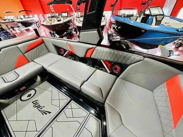 Slide: The Image of Interior of 2024 Tigé Z3 boat with gray and red seating, showroom display. - 14