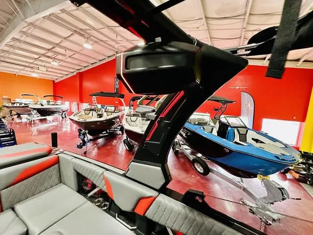 Slide: The Image of 2024 Tigé Z3 boats displayed in a showroom with other models. - 15