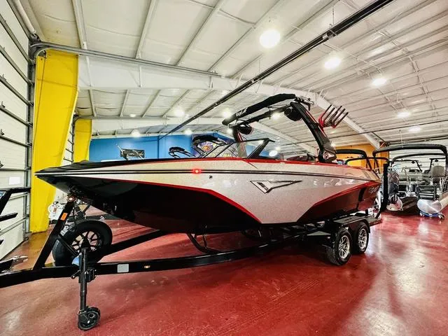 Slide: The Image of 2024 Tigé Z3 boat in showroom, black and red design, on trailer. - 3