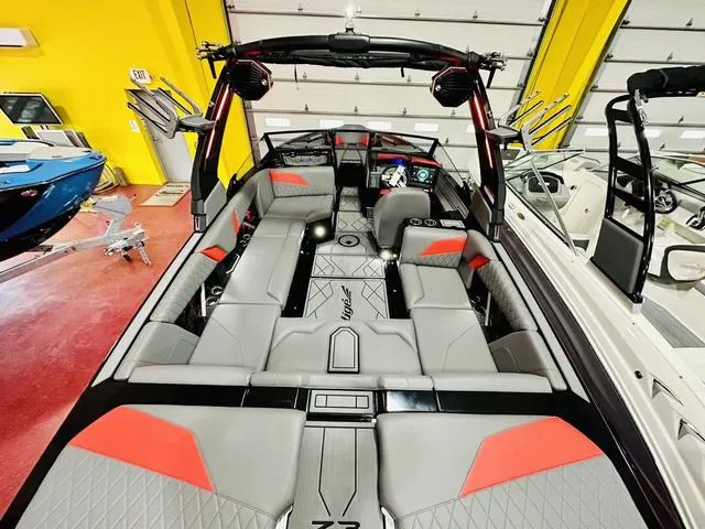Slide: The Image of 2024 Tigé Z3 boat interior with gray and red seating, advanced dashboard, and spacious layout. - 6