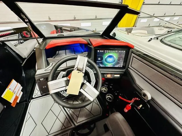Slide: The Image of 2024 Tigé Z3 boat dashboard with touchscreen display and modern steering wheel. - 8