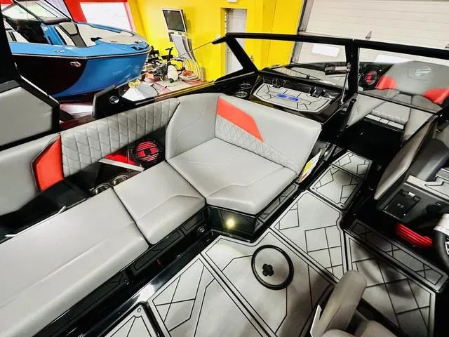 Slide: The Image of 2024 Tigé Z3 boat interior with gray and red seating, modern design. - 9