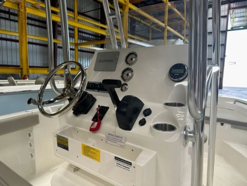 Slide: The Image of 2024 Key West 189 FS boat console with Garmin navigation system and stainless steel steering wheel. - 8