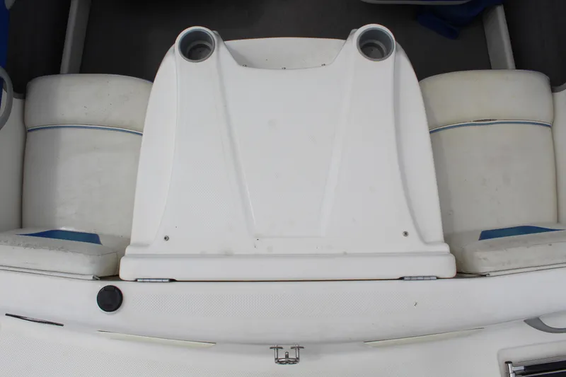 Slide: The Image of 2007 Bayliner 185 Bowrider boat interior with white seating and cup holders. - 14
