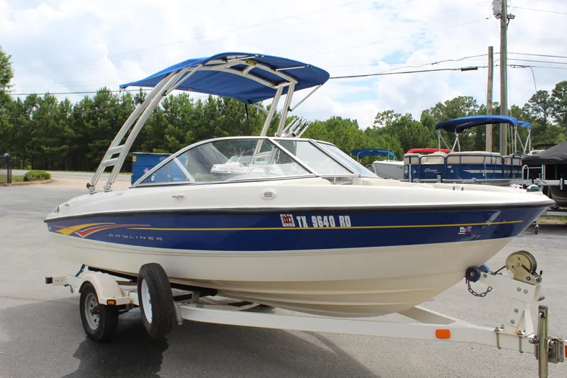 Slide: The Image of 2007 Bayliner 185 Bowrider boat on trailer with blue canopy in parking lot. - 5