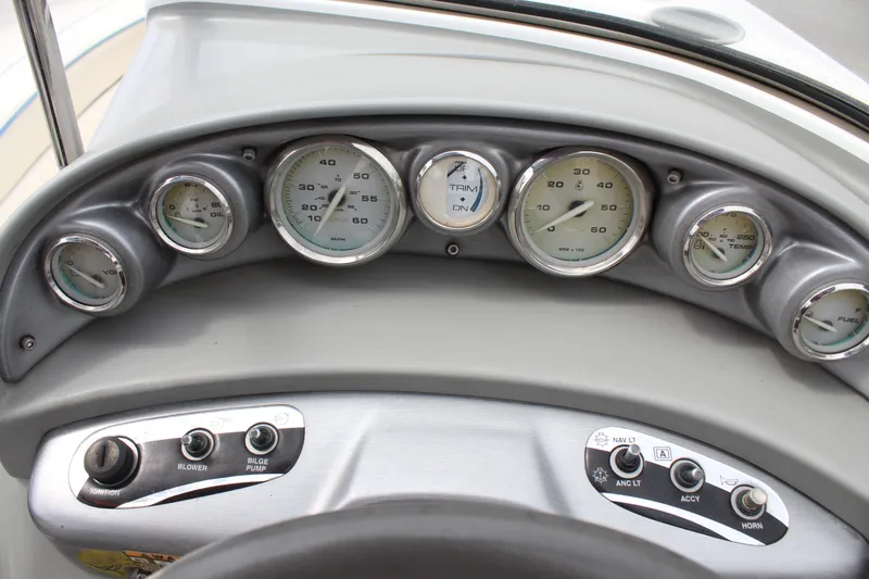 Slide: The Image of Dashboard of a 2007 Bayliner 185 Bowrider with gauges and control switches. - 9