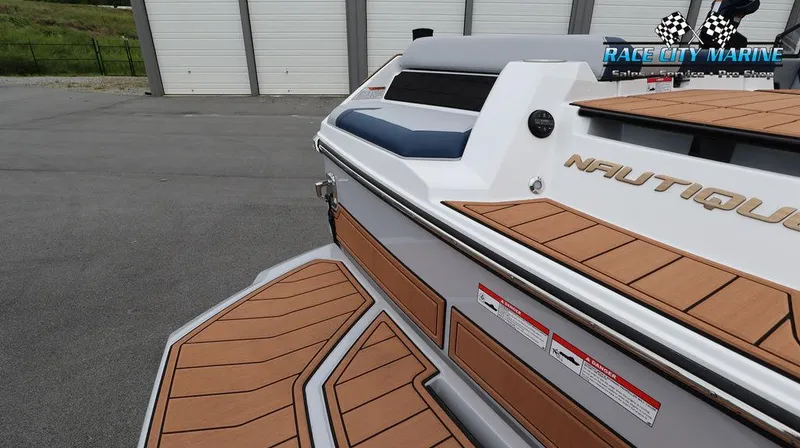 Slide: The Image of 2024 Nautique GS24 boat at Race City Marine, showcasing teak deck and sleek design. - 11