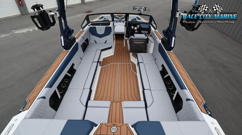 Slide: The Image of 2024 Nautique GS24 boat interior with spacious seating and teak flooring. - 15