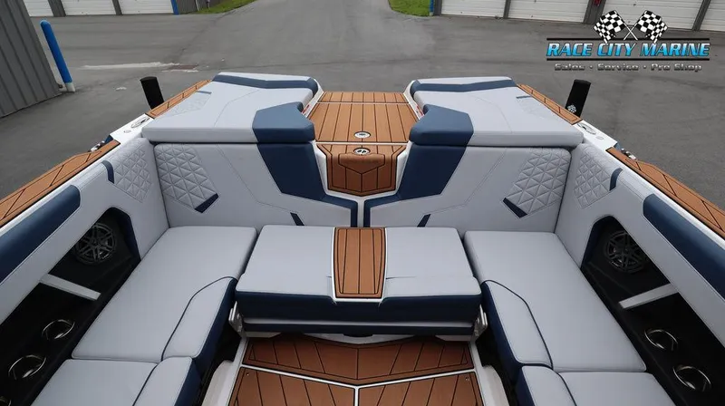 Slide: The Image of 2024 Nautique GS24 boat interior with luxurious seating and teak flooring. - 17
