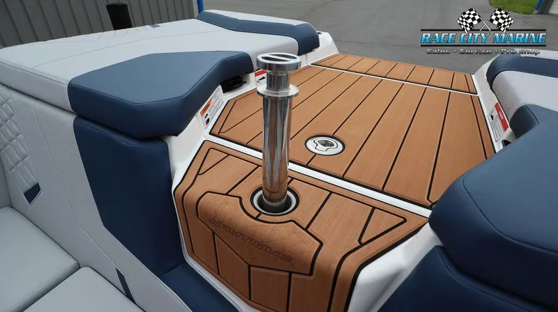 Slide: The Image of 2024 Nautique GS24 boat interior with teak flooring and blue upholstery. - 18