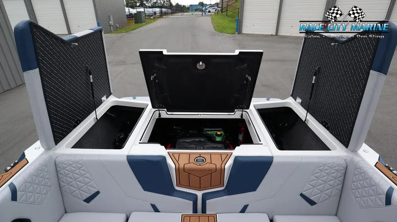 Slide: The Image of 2024 Nautique GS24 boat with open storage compartments and engine bay. - 19