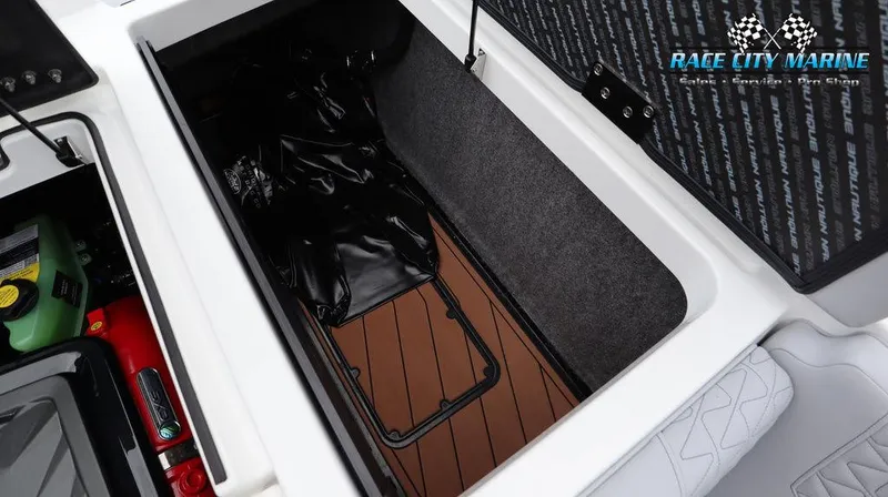 Slide: The Image of 2024 Nautique GS24 storage compartment with Race City Marine branding. - 21