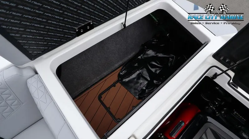 Slide: The Image of 2024 Nautique GS24 storage compartment with Race City Marine logo. - 22