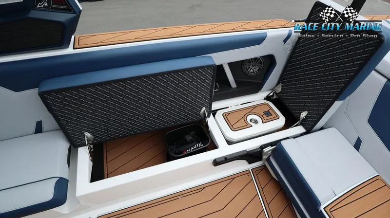Slide: The Image of 2024 Nautique GS24 boat interior storage compartments and seating. - 25