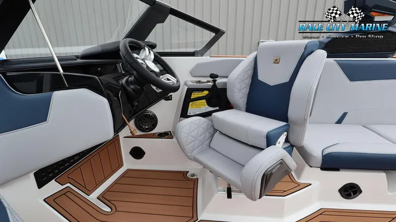 Slide: The Image of 2024 Nautique GS24 boat interior with modern dashboard and luxurious seating. - 33