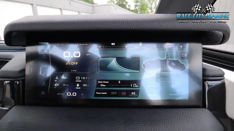 Slide: The Image of 2024 Nautique GS24 boat dashboard display showing speed, wake shape, and other controls. - 36