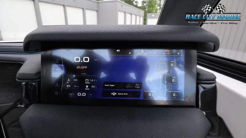 Slide: The Image of 2024 Nautique GS24 dashboard display with digital controls and navigation screen. - 38